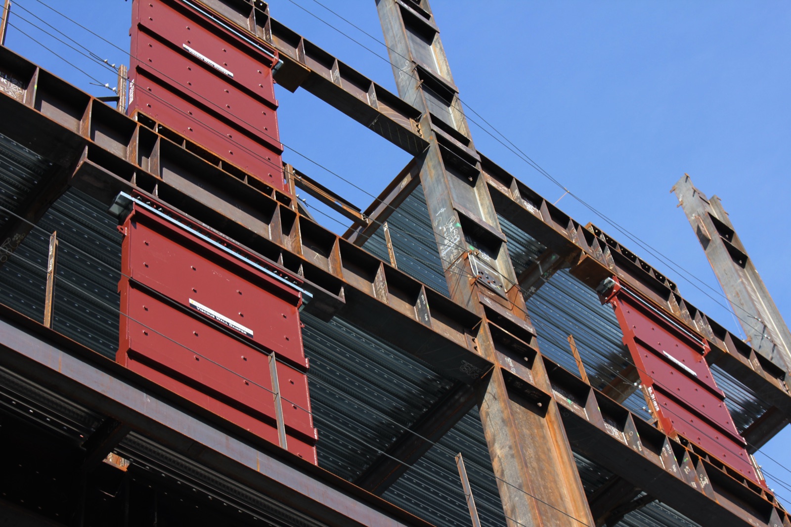 Viscous wall dampers installed in a steel building frame